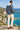Male coastal back-view look with cream trousers