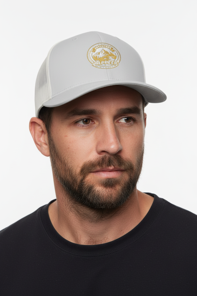 Male model close-up three-quarter view wearing silver trucker hat