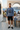 Male model in heather denim crewneck at coastal café