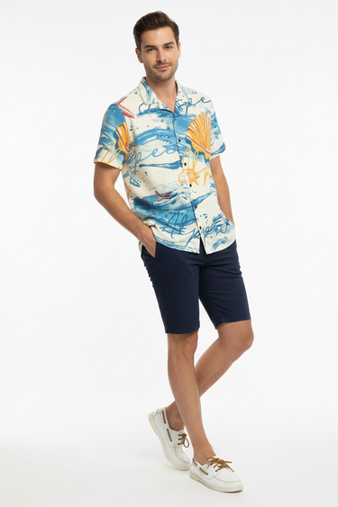 Male model in navy blue shorts and white boat shoes