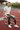Male model seated trackside wearing the patterned track pants