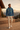 Male model wearing hoodie on alpine lodge deck