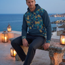 Male model wearing hoodie on coastal rooftop
