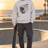 Male model wearing the ash sweatshirt beside a beachfront skate bowl