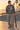 Male model wearing the graphite-heather sweatshirt beside a beachfront skate bowl