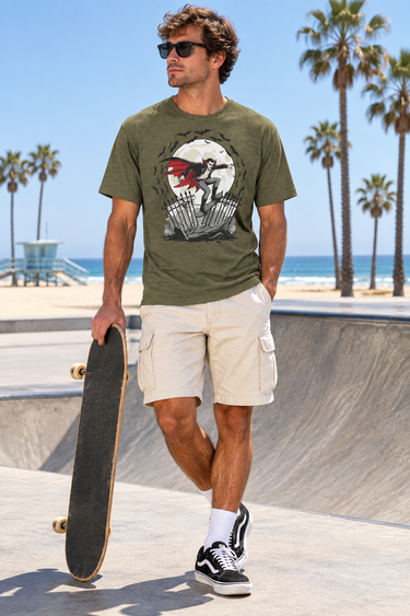 Male model wearing the heather-olive tee beside a sunlit beach skate ramp