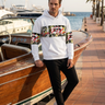 Male model wearing the hoodie with black joggers at a marina