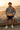 Male model wearing the hoodie with navy shorts