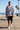 Male model wearing the newspaper-print sweatshirt with black boardshorts