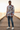 Male model wearing the newspaper-print sweatshirt with distressed blue jeans