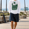 Male model wearing the ODDSON long-sleeve tee on a boardwalk