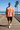 Male model wearing the sunburst sweatshirt with black boardshorts