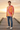 Male model wearing the sunburst sweatshirt with distressed blue jeans