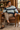 Male reading-chair look with sand trousers