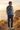 Male sweater back-view editorial with navy linen trousers