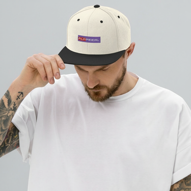 Man touching brim of natural and black snapback