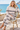 Matching Coastal Haze hoodie and joggers in a seated seaside café look