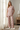 Matching floral pajama set beside sheer curtains