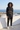 Matching hoodie and joggers on a seaside rooftop, front view