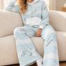 Matching pale-blue hoodie and wide-leg joggers in a cozy sofa look