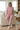Matching pink outfit in a coastal living room