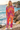 Matching tie-dye hoodie and wide-leg joggers, standing by the coast