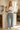 Model enjoying kitchen coffee in palm-print pajama pants