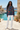 Model styled in distressed white jeans and canvas sneakers without accessories