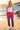 Model wearing tropical joggers on the beach