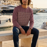 New male model seated at the marina