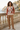 Pear V-neck sweater styled with camel trousers