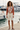 Pear V-neck sweater styled with cream tailored shorts