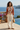 Pear V-neck sweater styled with ivory linen trousers