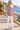 Pink hoodie back-detail look with white jeans