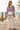 Pink hoodie with cream linen trousers on a boardwalk