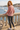 Red-haired model showing the sweater’s back artwork