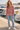 Red-haired model wearing the knitted sweater at a marina