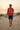 Red ODDSON tee styled for a beach-dune walk