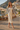 Reference model wearing floral bomber with ivory linen trousers