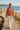 Rust mountain hoodie styled with cream linen trousers