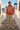 Rust mountain hoodie styled with sand chinos