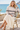 Seaside café look with an ivory pleated skirt