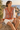 Seated look with orange geometric cardigan and ivory shorts