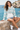 Seated seaside look with denim shorts