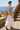 Short-haired reference model showcasing bomber back with linen maxi skirt