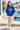Six-year-old girl in royal blue hoodie by the harbor