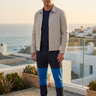 Stone jacket and joggers on a golden-hour terrace