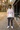 Teen boy wearing the white hoodie at a baseball field