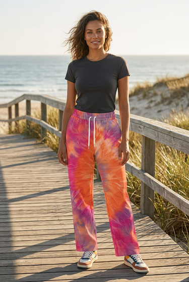Tie-dye joggers styled on a beach boardwalk