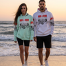 Vertical sunset beach editorial featuring both hoodie models
